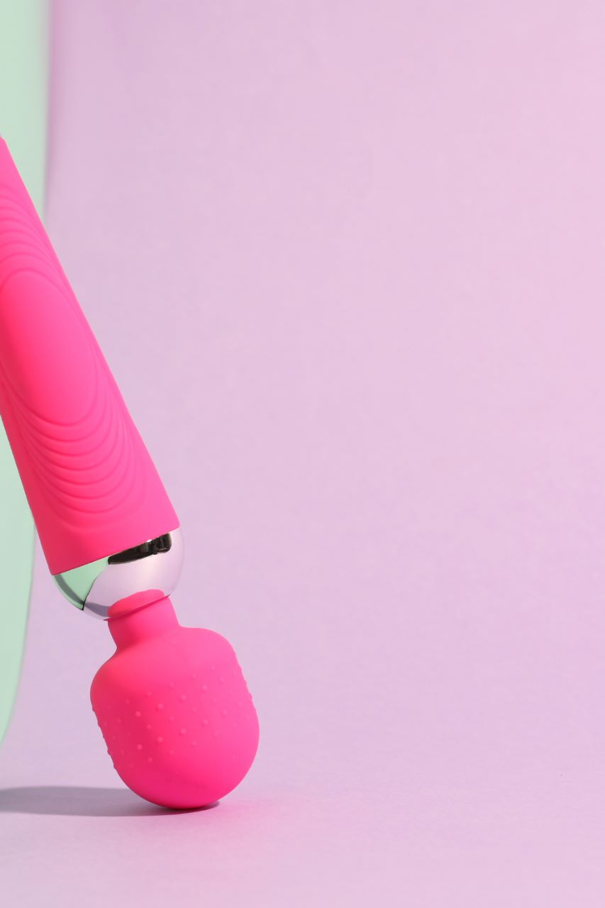 Wand massager on pastel color background