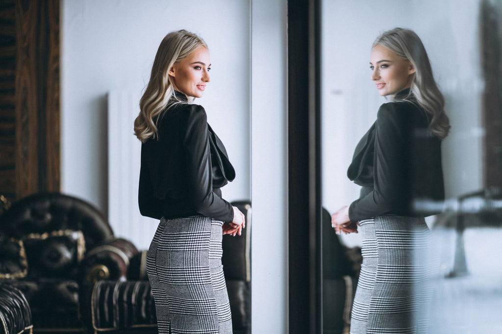 Attractive Business Woman wearing Black Blouse and Plaid Skirt