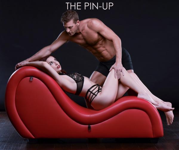 Red Leather sofa with women laying seductively and her male partner hovering over her.