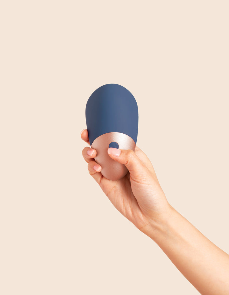Deia's AROUSER clitoral stimulator-held in hand-front of product being shown