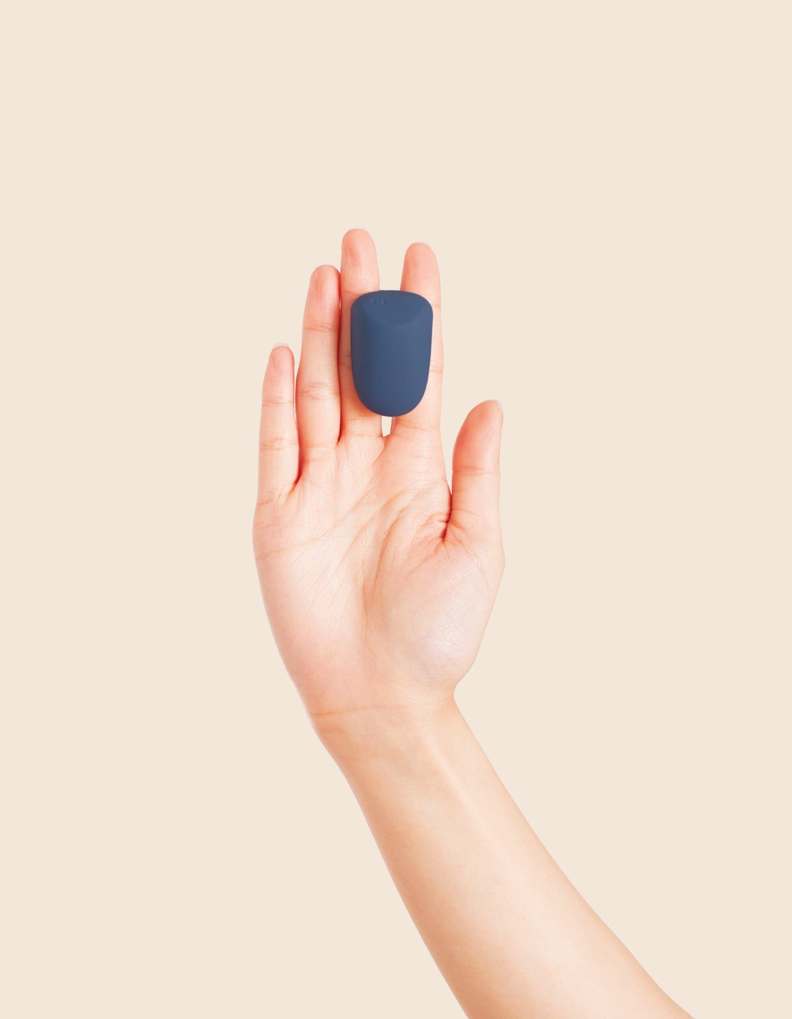Deia - the Wearable vibrator remote  being held between fingers