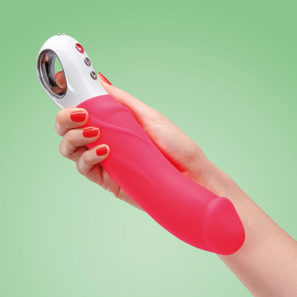 THE BIG BOSS: The Ultimate XL Vibrator by Fun Factory - Hot Pink Shown being held by a woman's hand in the getting ready to use position